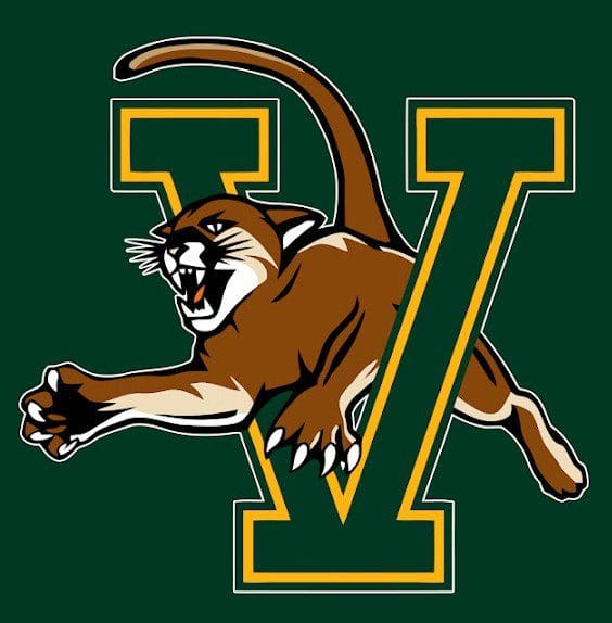 A fierce cougar leaping through a large green and yellow letter V.