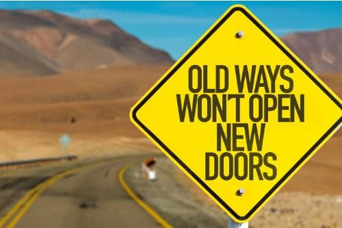Road sign with motivational quote about change in a desert setting.
