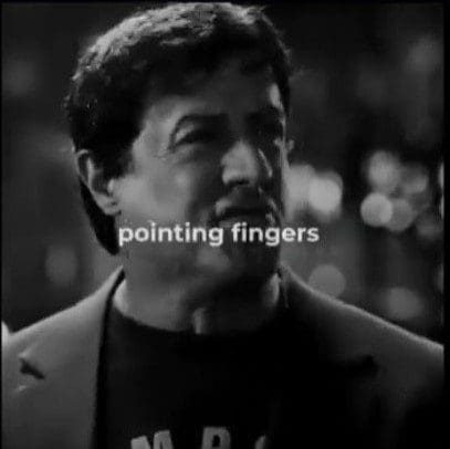 A man pointing fingers in a black and white image.