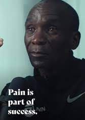 A man with a serious expression and a motivational quote about pain.