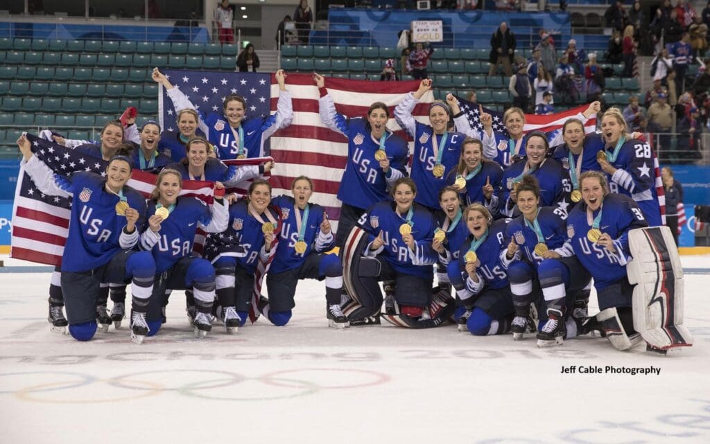 USA women's hockey team celebrates gold victory.