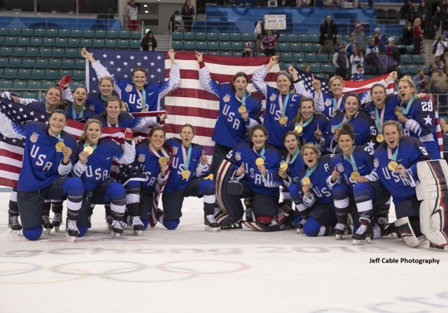 USA women's hockey team celebrates gold victory.