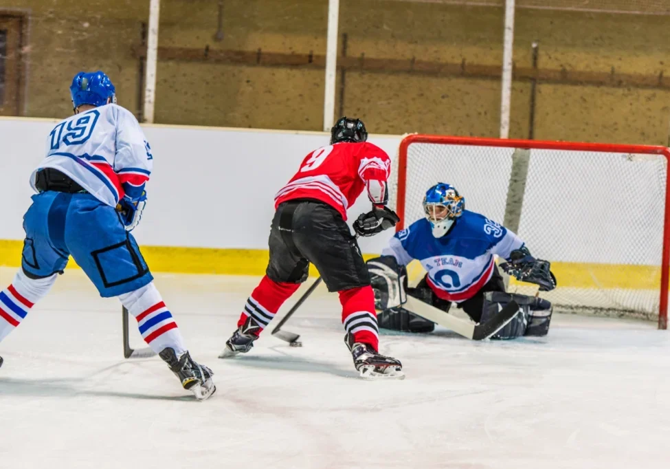 Ice hockey players shooting on goal.