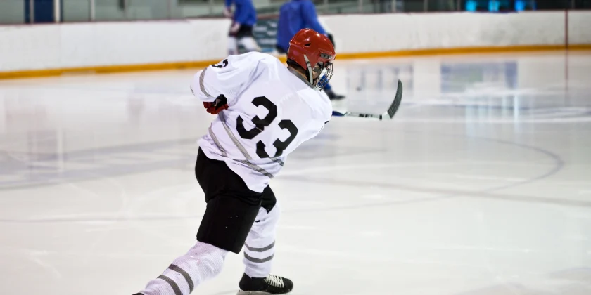 Hockey player #33 skating on ice.