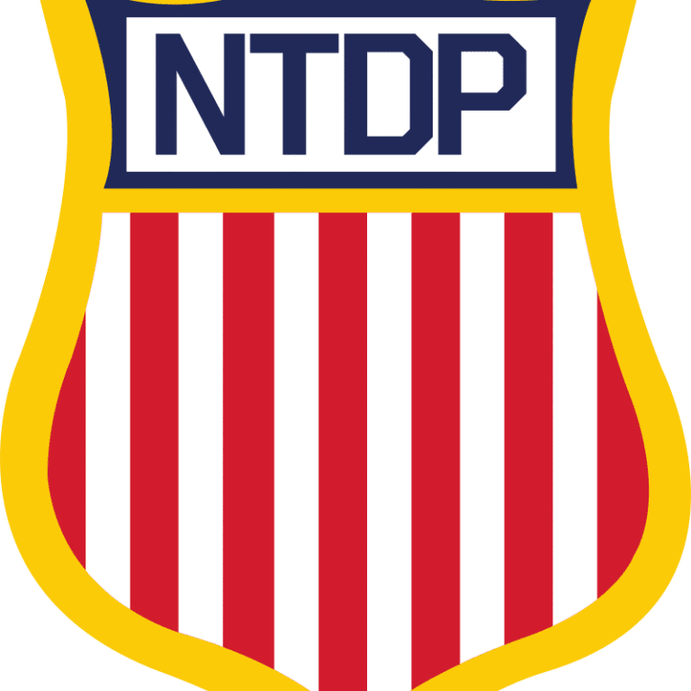 Shield-shaped emblem with NTDP and red-white stripes.