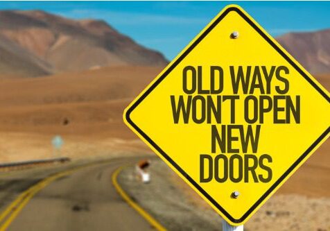 Road sign with motivational quote about change in a desert setting.