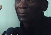 A man with a serious expression and a motivational quote about pain.