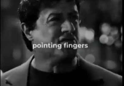 A man pointing fingers in a black and white image.