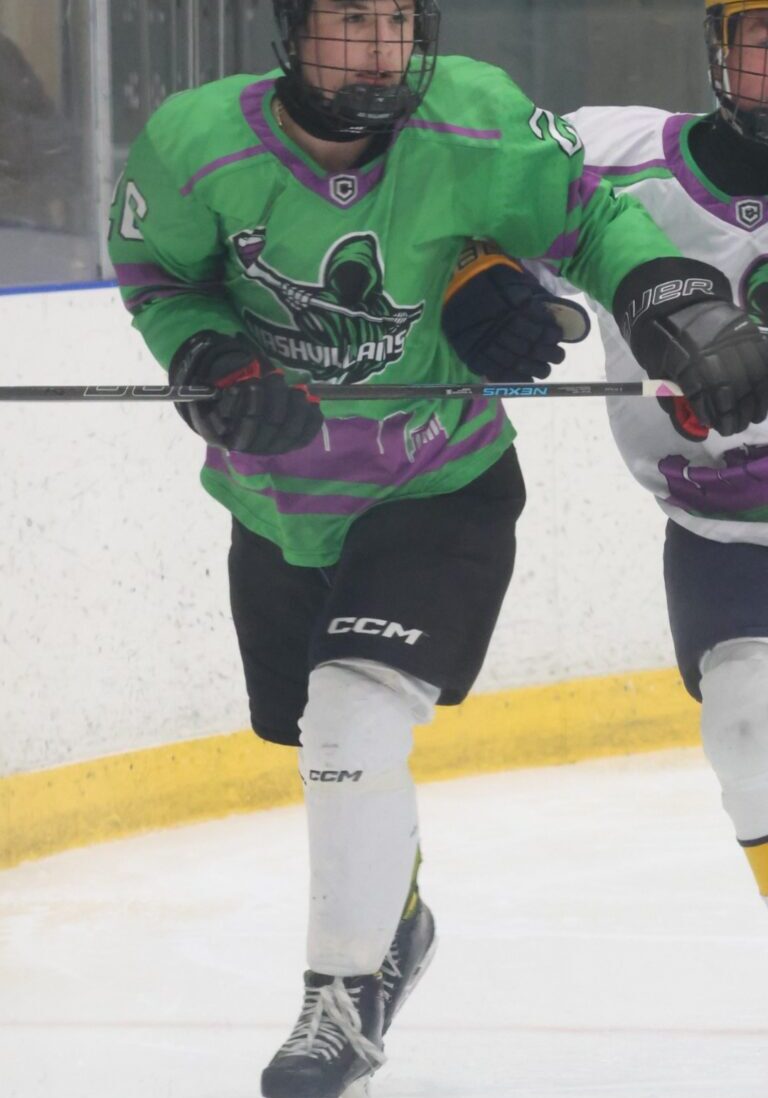 Two ice hockey players in action, wearing colorful jerseys and protective gear.