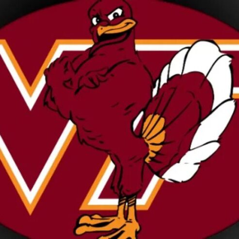 Virginia Tech Hokies mascot holding a basketball in front of the VT logo.