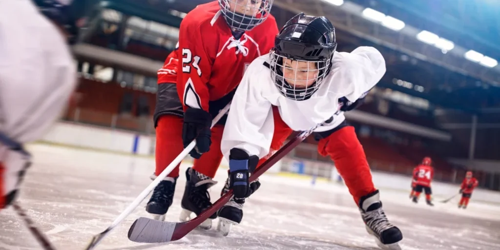 Youth hockey players battling for the puck.